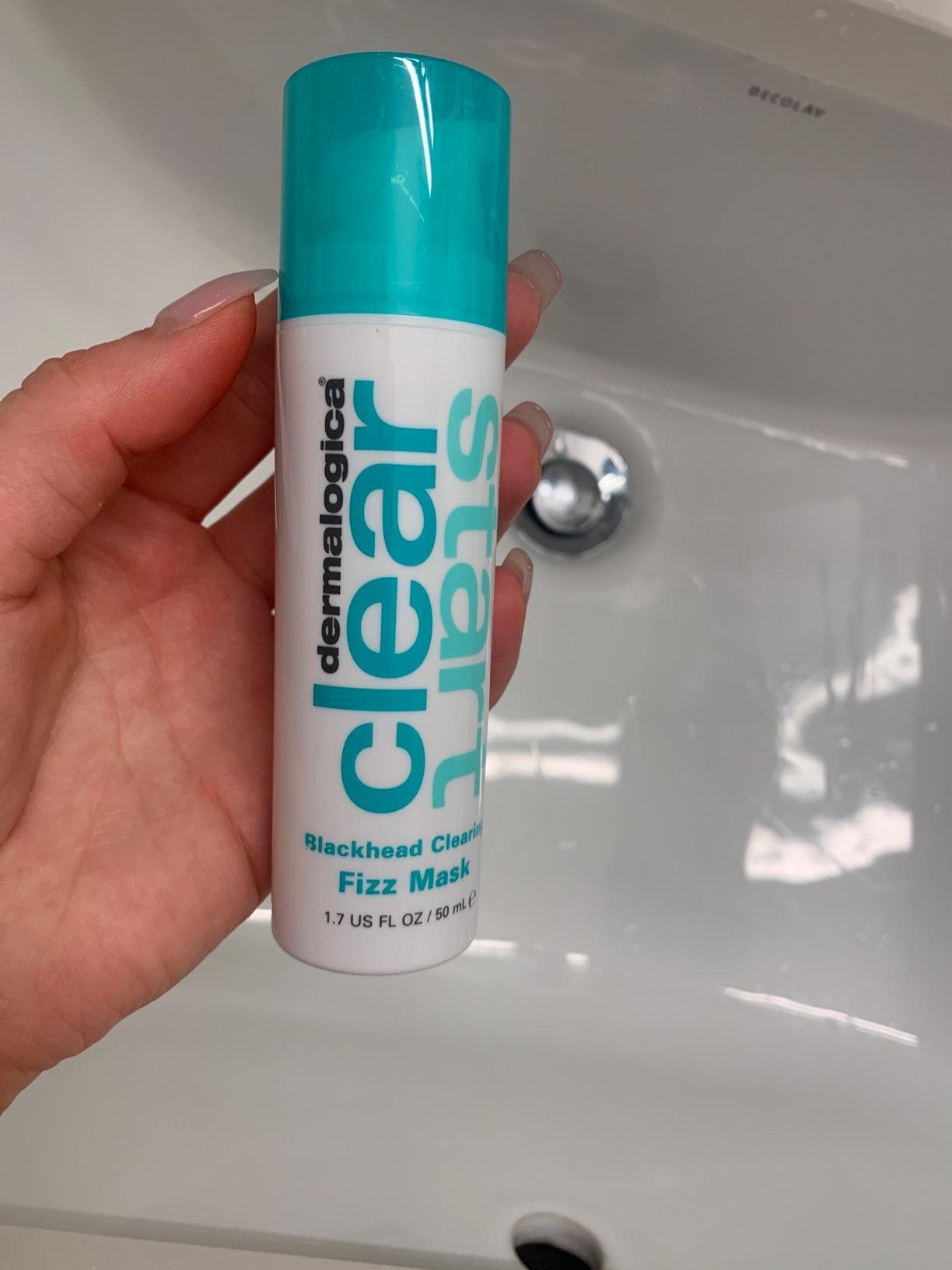 Dermalogica Clear Start Blackhead Clearing Fizz Mask bottle held over a sink