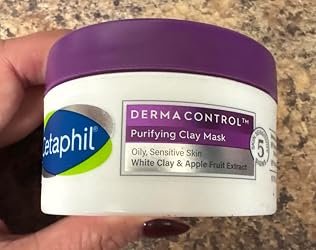 Cetaphil DermaControl Purifying Clay Mask jar held in hand