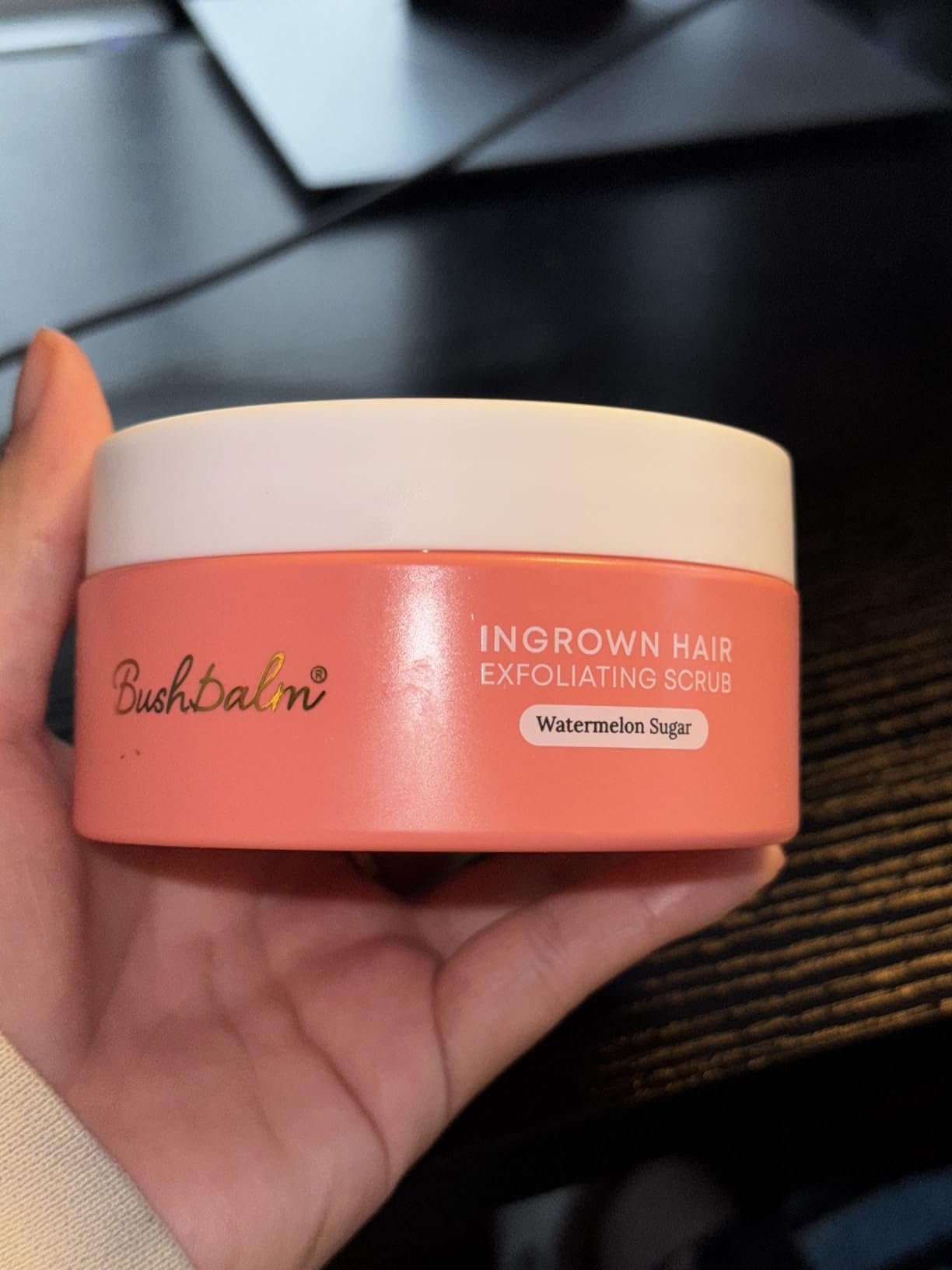 Bushbalm Watermelon Sugar Ingrown Hair Scrub jar held in hand