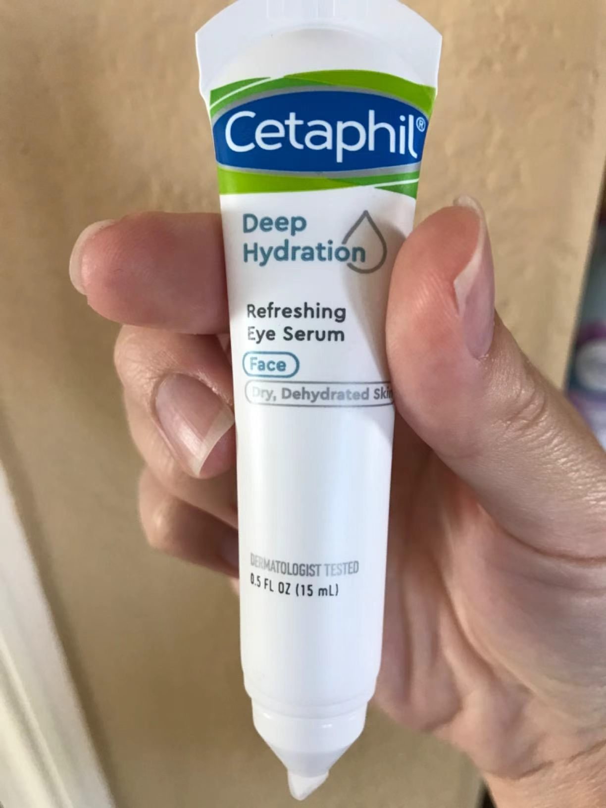 Cetaphil Deep Hydration Refreshing Eye Serum tube held in hand