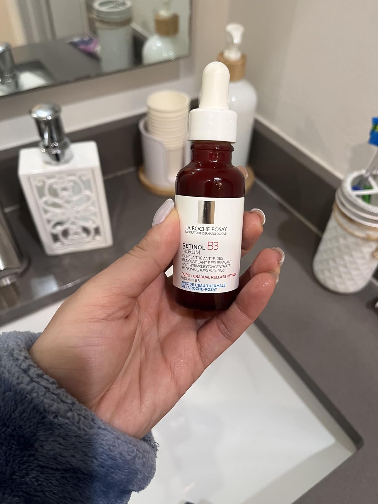 Hand holding a bottle of La Roche-Posay Retinol B3 Face Serum