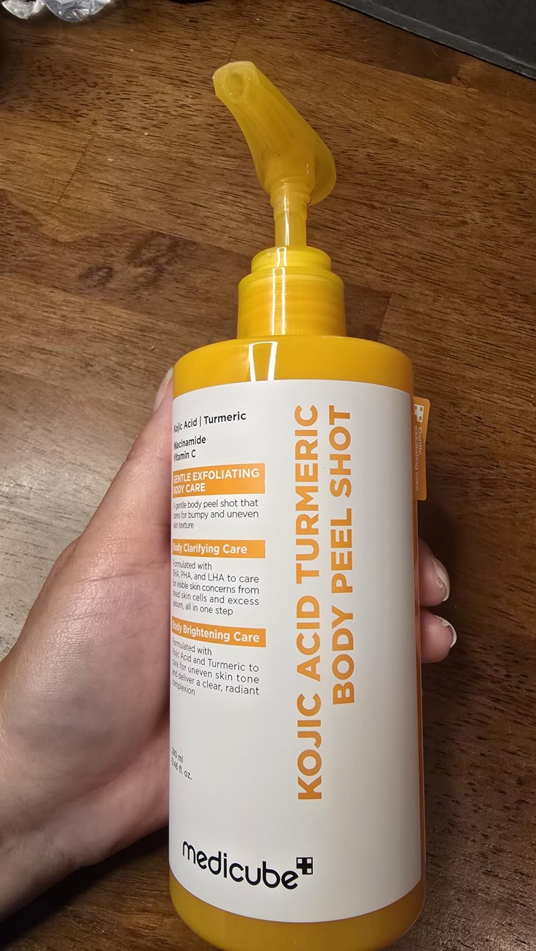 medicube Kojic Acid Turmeric Body Peel Shot bottle held in hand