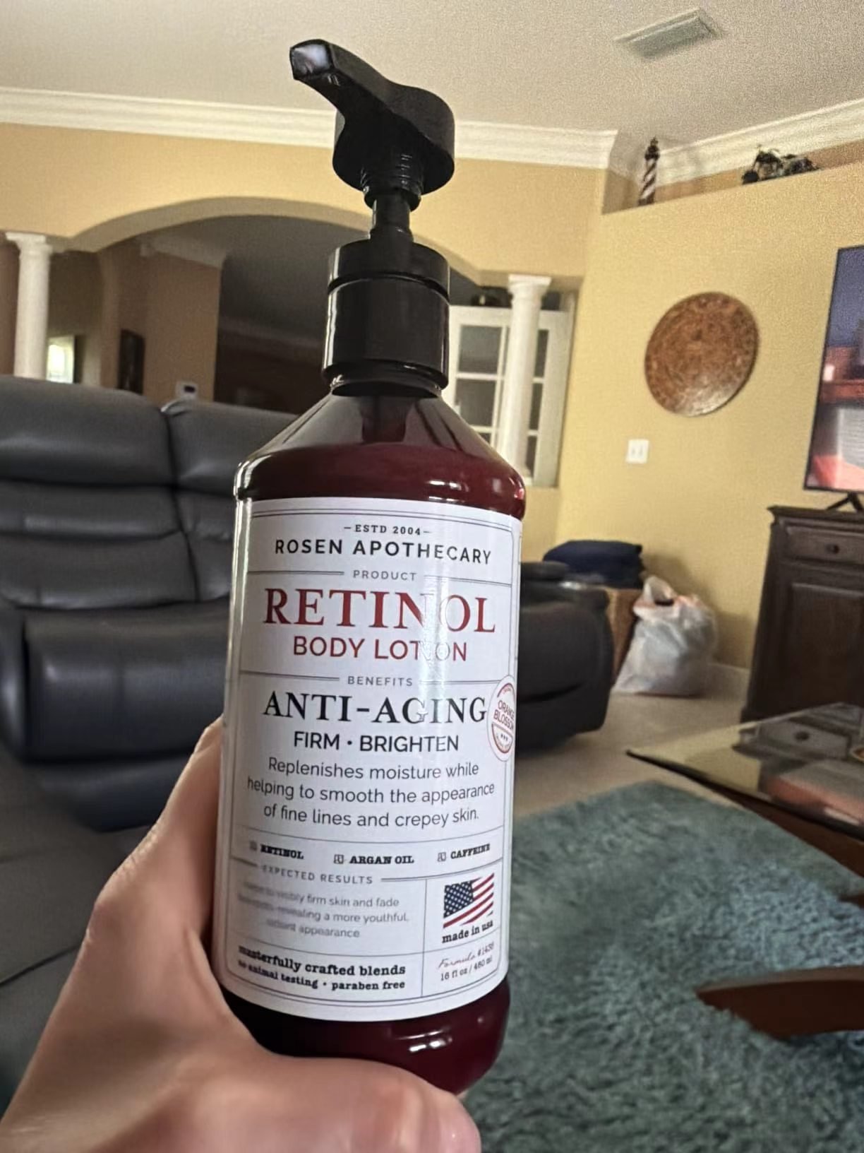 Rosen Apothecary Retinol Body Lotion pump bottle held in hand